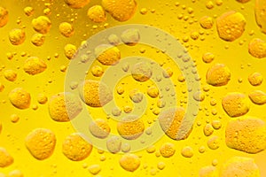 Oil mixed in water on a colorful yellow orange and golden background. Photographed in close up with shallow DOF.Photo taken: