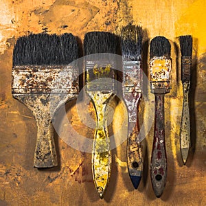 Oil paint brushes on wood painted background