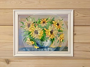 Oil painting flowers on the wall in the interior. Drawn sunflowers in a vase.