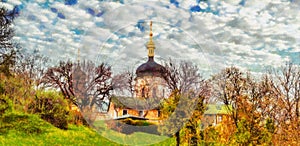 Oil painting landscape, colorful trees on the background of the church. Outdoor landscape