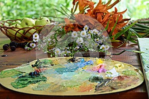 Oil painting on nature, palette with multi-colored oil paints,