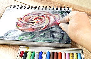 Oil pastels crayons colorful picking art drawing on wood table. photo