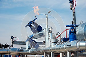 Oil pipes and valves and gas flame in refinery
