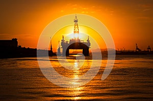 Oil Platform in Bay by Sunset