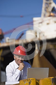 An oil platform inspector with his laptop