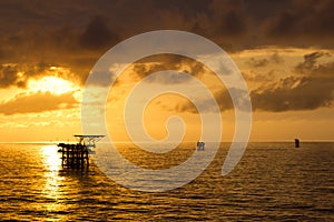 Oil platforms at sunrise