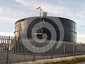 Oil products tall metal storage. Tank for diesel or petrol fuel distribution and import or export by major market players.