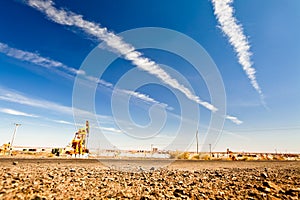 Oil pump at desert with sunny sky