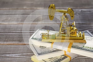 Oil pump extraction of black gold, dollars on wads of money photo