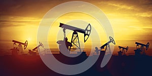 Oil pump jacks on sunset sky background