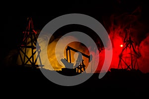 Oil pump oil rig energy industrial machine for petroleum, Group oil rigs and brightly lit industrial site at night. Toned.Backgrou