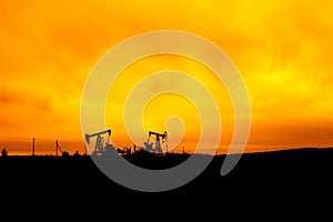 Oil pump oil rig energy industrial machine for petroleum in the sunset background for design.