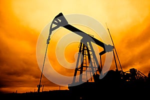 Oil pump oil rig energy industrial machine for petroleum in the sunset background for design.