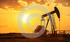 Oil pump oil rig energy industrial machine for petroleum in the sunset background