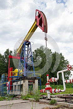 Oil pump raised high against the sky