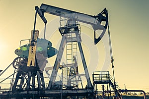 Oil pump rig. Oil and gas production. Oilfield site. Pump Jack are running. Drilling derricks for fossil fuels output