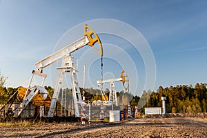 Oil pump rig. Oil and gas production. Oilfield site. Pump Jack are running. Drilling derricks for fossil fuels output