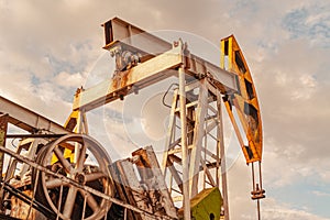 Oil pump rig. Oil and gas production. Oilfield site. Pump Jack are running. Drilling derricks for fossil fuels output