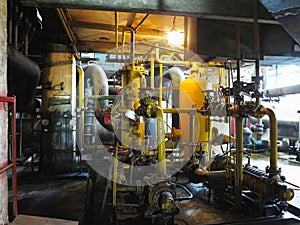 Oil pump, yellow pipes, tubes, machinery at power plant