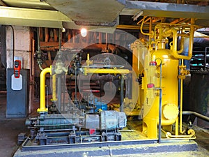 Oil pump, yellow pipes, tubes, machinery at power plant