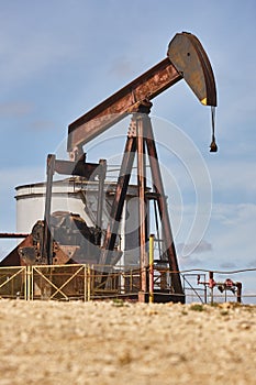 Oil pumping machine and fuel tank. Petroleum extraction. Global warming