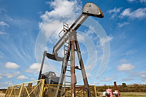 Oil pumping machine. Pump jack. Petroleum extraction. Global warming