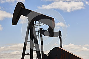 Oil pumping machine. Pump jack. Petroleum extraction. Global warming