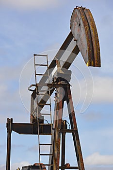 Oil pumping machine. Pump jack. Petroleum extraction. Global warming