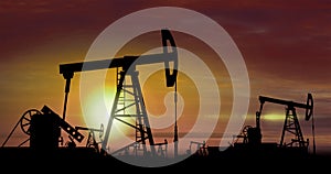 Oil pumps - oil extraction on sunset background photo