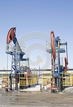 Oil pumps and gasl torch. Oil industry. Gas industry.
