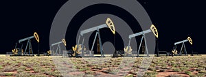 Oil pumps in a landscape at night