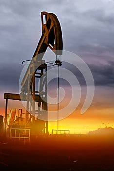 Oil pumps at sunset, industrial oil pumps equipment. Sunset and darkness. Oil field in the fog. Crisis in the oil