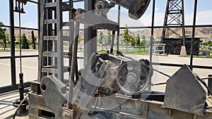 Oil pumps working on a field. Metal oil derricks work, pumping oil, close up.