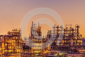 Oil refinery industrial plant or factory at sunset, storage distillery tanks and steel pipeline, modern petrochemical technologies