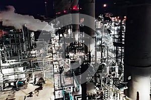 Oil refinery at night lit. Construction of an oil industrial fac