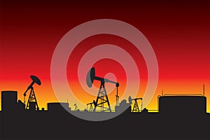 Oil refinery and oil pumps silhouettes in sunset