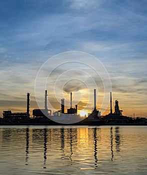 Oil refinery or petrochemical industry plant at sunrise