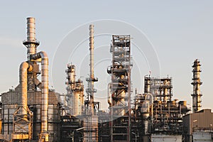 Oil refinery plant on blue sky on sunset background