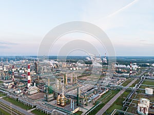 Oil refinery plant industry, Refinery factory, oil storage tank and pipeline steel with sunrise and cloudy sky