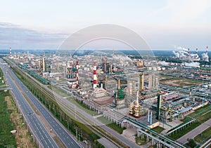 Oil refinery plant industry, Refinery factory, oil storage tank and pipeline steel with sunrise and cloudy sky