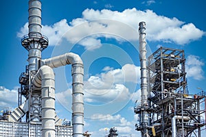 Oil refinery plant from industry zone, Oil and gas petrochemical industrial with tree and blue sky background, Refinery factory
