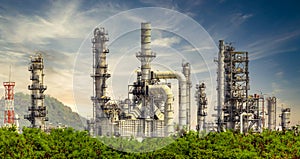 Oil refinery plant from industry zone, Oil and gas petrochemical industrial with tree and blue sky background, Refinery factory