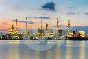Oil refinery river front with sunrise sky background