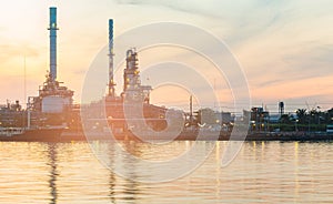 Oil refinery river front with sunset sky