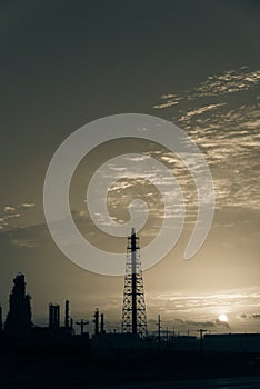 Oil refinery silhouette at sunrise