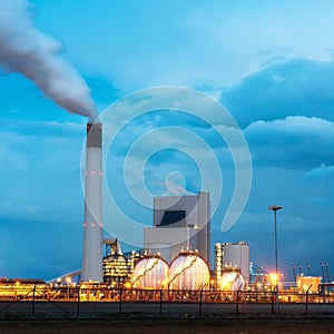 Oil refinery with smoking at twilight. Oil refinery in Rotterdam.