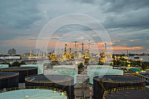 Oil refinery and storage tank at twilight