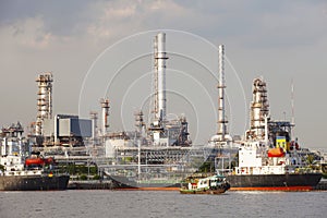 Oil refinery and tanker ship on port in heavy industry use for e