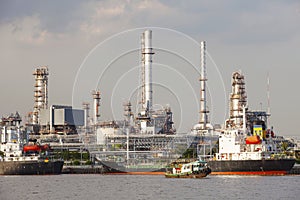 Oil refinery and tanker ship on port in heavy industry use for e photo