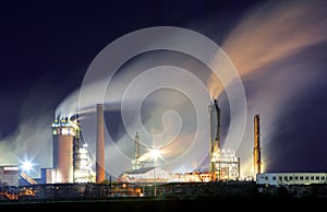 Oil refinery with vapor - petrochemical industry at night